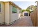 Side yard view showcasing a detached garage and brick driveway at 2812 W Neptune St, Tampa, FL 33629