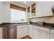 Modern kitchen with white cabinets, granite countertops, and stainless steel appliances at 2812 W Neptune St, Tampa, FL 33629