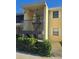 Condo building exterior featuring a stairway and landscaping at 3001 58Th S Ave # 203, St Petersburg, FL 33712