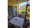 Relaxing screened patio with table and chairs and view to nature at 3001 58Th S Ave # 203, St Petersburg, FL 33712