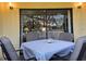 Screened patio with table and chairs, perfect for outdoor dining at 3001 58Th S Ave # 203, St Petersburg, FL 33712