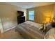 Cozy bedroom with a queen bed, dresser and window at 3001 58Th S Ave # 701, St Petersburg, FL 33712