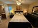 Bedroom with a queen-size bed, ensuite bathroom access, and ceiling fan at 3001 58Th S Ave # 701, St Petersburg, FL 33712