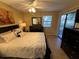 Comfortable bedroom with a queen-size bed and patio access at 3001 58Th S Ave # 701, St Petersburg, FL 33712