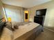 Bright bedroom with a queen bed, dresser and window at 3001 58Th S Ave # 701, St Petersburg, FL 33712