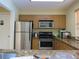 Simple kitchen with stainless steel appliances and wood cabinets at 3001 58Th S Ave # 701, St Petersburg, FL 33712