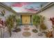 Welcoming entryway with yellow door and tropical landscaping at 3435 Roxbury Dr, Holiday, FL 34691