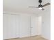 Bright bedroom with ceiling fan, closet, and door at 3630 E North Bay St, Tampa, FL 33610