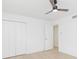 Bright bedroom with ceiling fan, double doors and light flooring at 3630 E North Bay St, Tampa, FL 33610