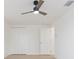 Bright bedroom with ceiling fan, closet, and door at 3630 E North Bay St, Tampa, FL 33610