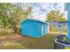 Detached garage with blue exterior and grassy surroundings at 3630 E North Bay St, Tampa, FL 33610