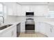 Modern kitchen with stainless steel appliances and white cabinets at 3630 E North Bay St, Tampa, FL 33610