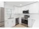 Modern kitchen with stainless steel appliances and white cabinets at 3630 E North Bay St, Tampa, FL 33610