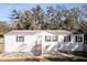 White single-wide manufactured home with gray shutters and metal stairs at 3752 Elfers Pkwy, New Port Richey, FL 34655