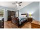 Guest bedroom with wood floors and a ceiling fan at 3838 Muirfield Ct, Palm Harbor, FL 34685