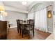 Bright dining room with hardwood floors and large window at 3838 Muirfield Ct, Palm Harbor, FL 34685