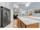 Modern kitchen featuring stainless steel appliances and a large island at 3838 Muirfield Ct, Palm Harbor, FL 34685