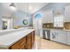 Spacious kitchen with island, stainless steel appliances, and light blue walls at 3838 Muirfield Ct, Palm Harbor, FL 34685