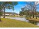 Community features a serene lake with lush landscaping at 3838 Muirfield Ct, Palm Harbor, FL 34685