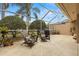 Enjoy this screened patio with comfortable seating and string lights at 3838 Muirfield Ct, Palm Harbor, FL 34685