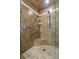 Large walk-in shower with tiled walls and built-in seat at 3838 Muirfield Ct, Palm Harbor, FL 34685