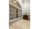 Sunroom with large windows and terracotta-colored floor at 3838 Muirfield Ct, Palm Harbor, FL 34685