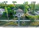 House with a walkway, surrounded by lush tropical landscaping and palm trees at 4056 18Th S Ave, St Petersburg, FL 33711