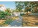 Landscaped backyard with a walkway leading to a detached building at 4056 18Th S Ave, St Petersburg, FL 33711