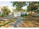 Landscaped backyard with a walkway leading to a detached building at 4056 18Th S Ave, St Petersburg, FL 33711