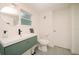 Clean bathroom with teal vanity and floating sink at 4056 18Th S Ave, St Petersburg, FL 33711