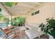 Relaxing covered patio with seating area, lush tropical plants, and a hammock at 4056 18Th S Ave, St Petersburg, FL 33711