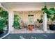 Relaxing covered patio with seating area and lush tropical plants at 4056 18Th S Ave, St Petersburg, FL 33711