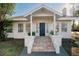 Quaint white house with a blue door and terracotta tiled steps at 4056 18Th S Ave, St Petersburg, FL 33711