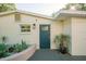 White home exterior with gray door and landscaping at 4056 18Th S Ave, St Petersburg, FL 33711