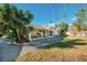 House exterior showcasing a covered patio area and well-maintained lawn at 4056 18Th S Ave, St Petersburg, FL 33711