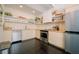 Modern kitchen with light wood cabinets, stainless steel appliances, and open shelving at 4056 18Th S Ave, St Petersburg, FL 33711