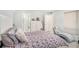 Main bedroom with floral bedding, and access to the bathroom at 4154 Pinelake Ln # 101, Tampa, FL 33618