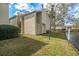 Light beige condo exterior with a private yard and water view at 4154 Pinelake Ln # 101, Tampa, FL 33618