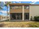 Rear view of condo showing patio and screened enclosure at 4154 Pinelake Ln # 101, Tampa, FL 33618