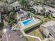 Aerial view of community pool and surrounding landscape at 4154 Pinelake Ln # 101, Tampa, FL 33618