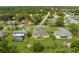 Aerial view of neighborhood with a tan house, pool, and other homes at 4522 Gondolier Rd, Spring Hill, FL 34609