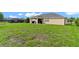 Large grassy backyard with covered patio at 4522 Gondolier Rd, Spring Hill, FL 34609