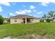 Large backyard with covered patio and grassy area at 4522 Gondolier Rd, Spring Hill, FL 34609