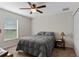 Spacious bedroom with ceiling fan and large window at 4522 Gondolier Rd, Spring Hill, FL 34609