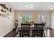 Bright dining room with dark wood floors and six chairs at 4522 Gondolier Rd, Spring Hill, FL 34609