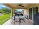 Covered patio with table, chairs and grill at 4522 Gondolier Rd, Spring Hill, FL 34609