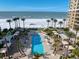 Aerial view of resort-style pool, beach, and building at 470 Mandalay Ave # 306, Clearwater Beach, FL 33767