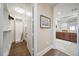 View of bathroom from hallway, showing double sinks at 470 Mandalay Ave # 306, Clearwater Beach, FL 33767