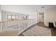 Upper hallway with wood floors, white railing, and city views at 470 Mandalay Ave # 306, Clearwater Beach, FL 33767