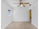 This bedroom features a ceiling fan, a window that lets in natural light, and neutral carpet flooring at 504 Holly Ln, Brandon, FL 33510